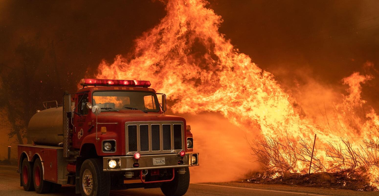 A Los Angeles County fire truck attacks flames in Valyermo, California.