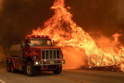 A Los Angeles County fire truck attacks flames in Valyermo, California.