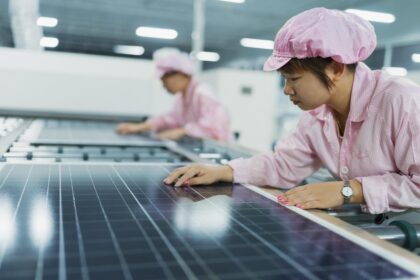 Female workers in solar panel assembly factory, Solar Valley, Dezhou, China.